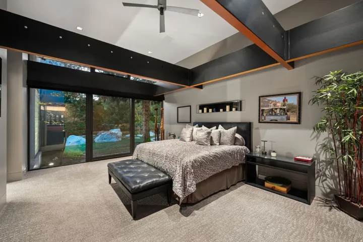 Vaulted ceiling with exposed beams, recessed lighting, and a ceiling fan
