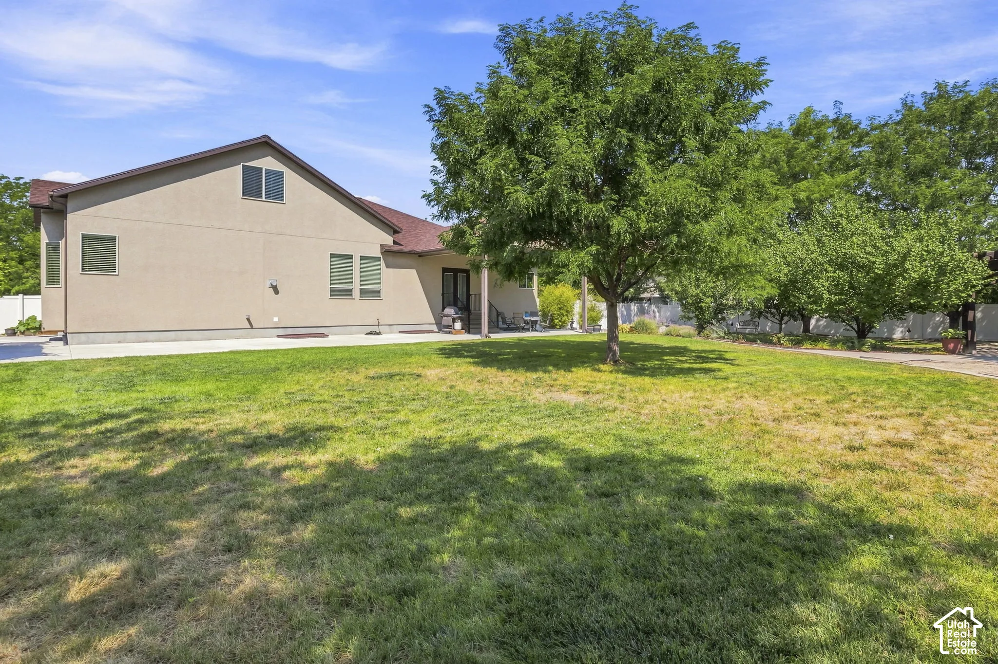 Exterior with stucco finish, multiple windows, and a covered patio