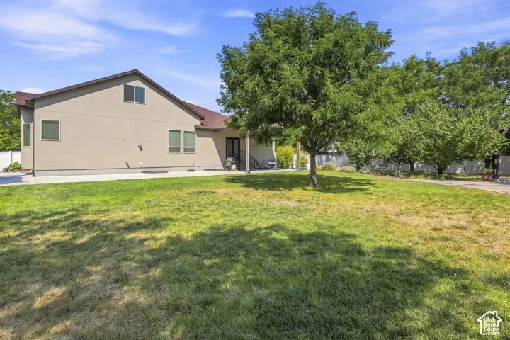 Exterior with stucco finish, multiple windows, and a covered patio