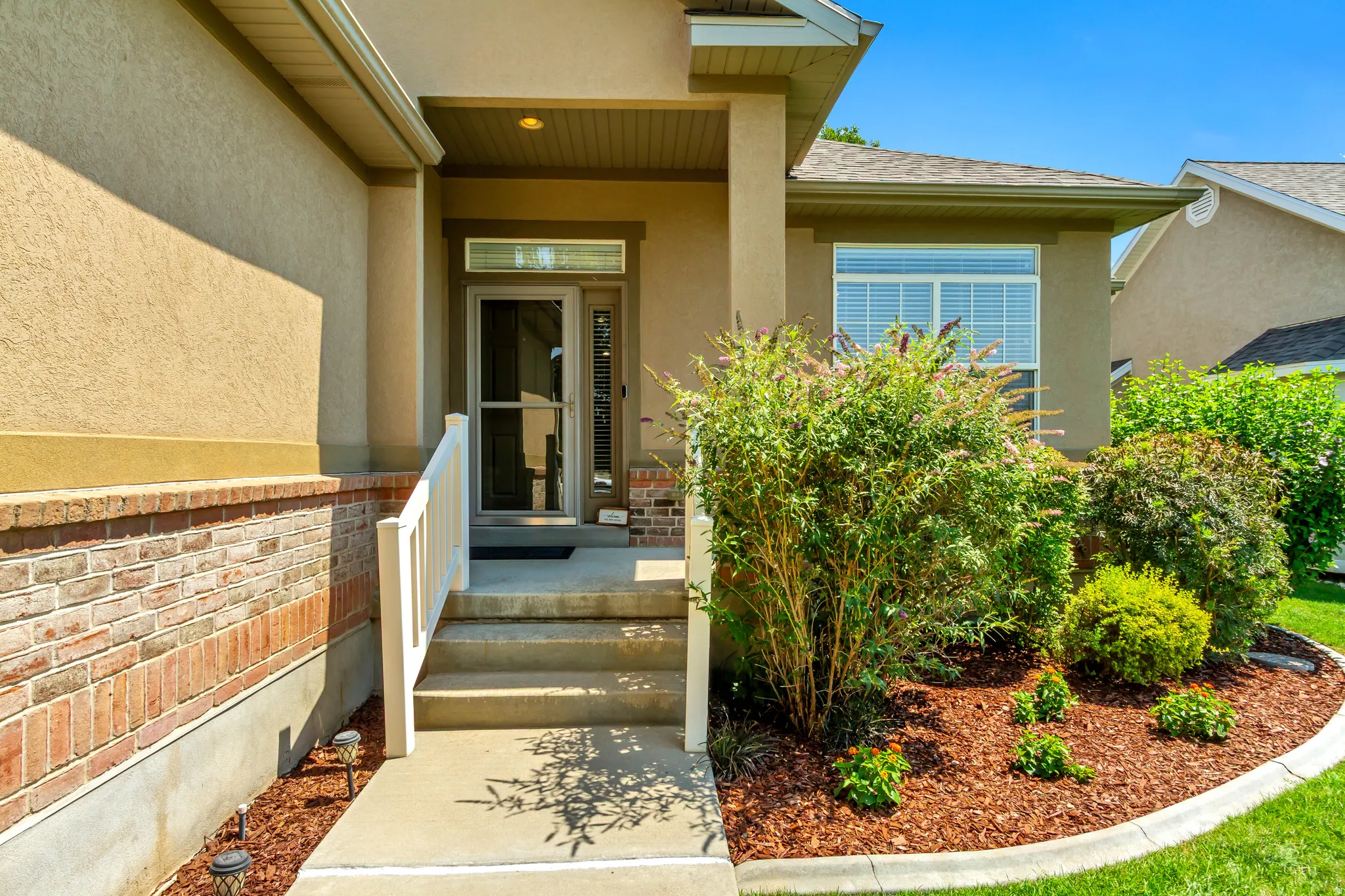 Covered entry with full glass storm door.