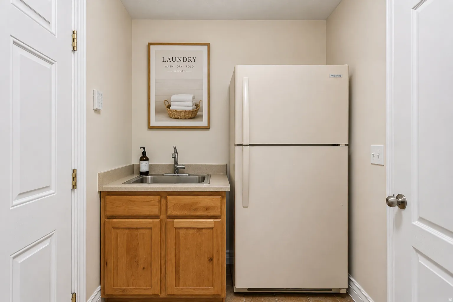 Virtually staged to show possibilities.  Fridge is virtually staged to show space available for a fridge.  Outlet for fridge is on right wall.