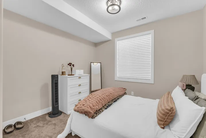 Neutral wall finishes complement the textured ceiling