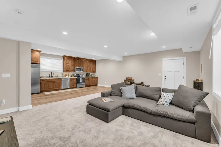 Full kitchen with wood cabinetry and stainless steel appliances