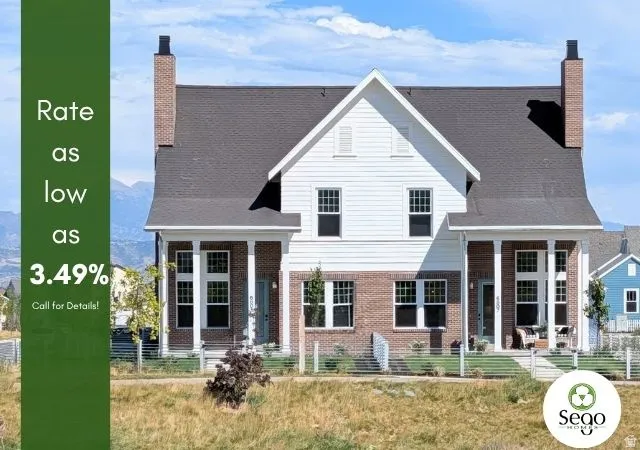 Brick and white siding exterior with a dark shingle roof