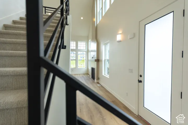 Carpeted staircase with black metal railing