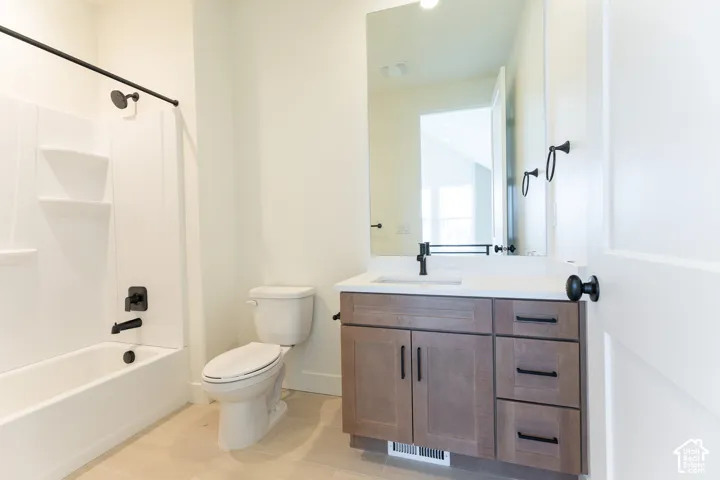 Bathroom featuring a contemporary vanity with a white countertop, an integrated sink, and matte black fixtures