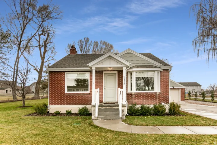 Brick exterior with a gabled roof and bay window