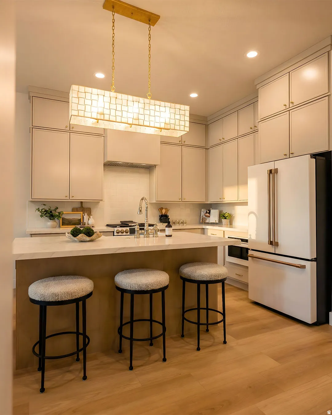 Kitchen featuring a center island, recessed lighting, wood-finish flooring, full-height cabinetry, and stainless steel appliances