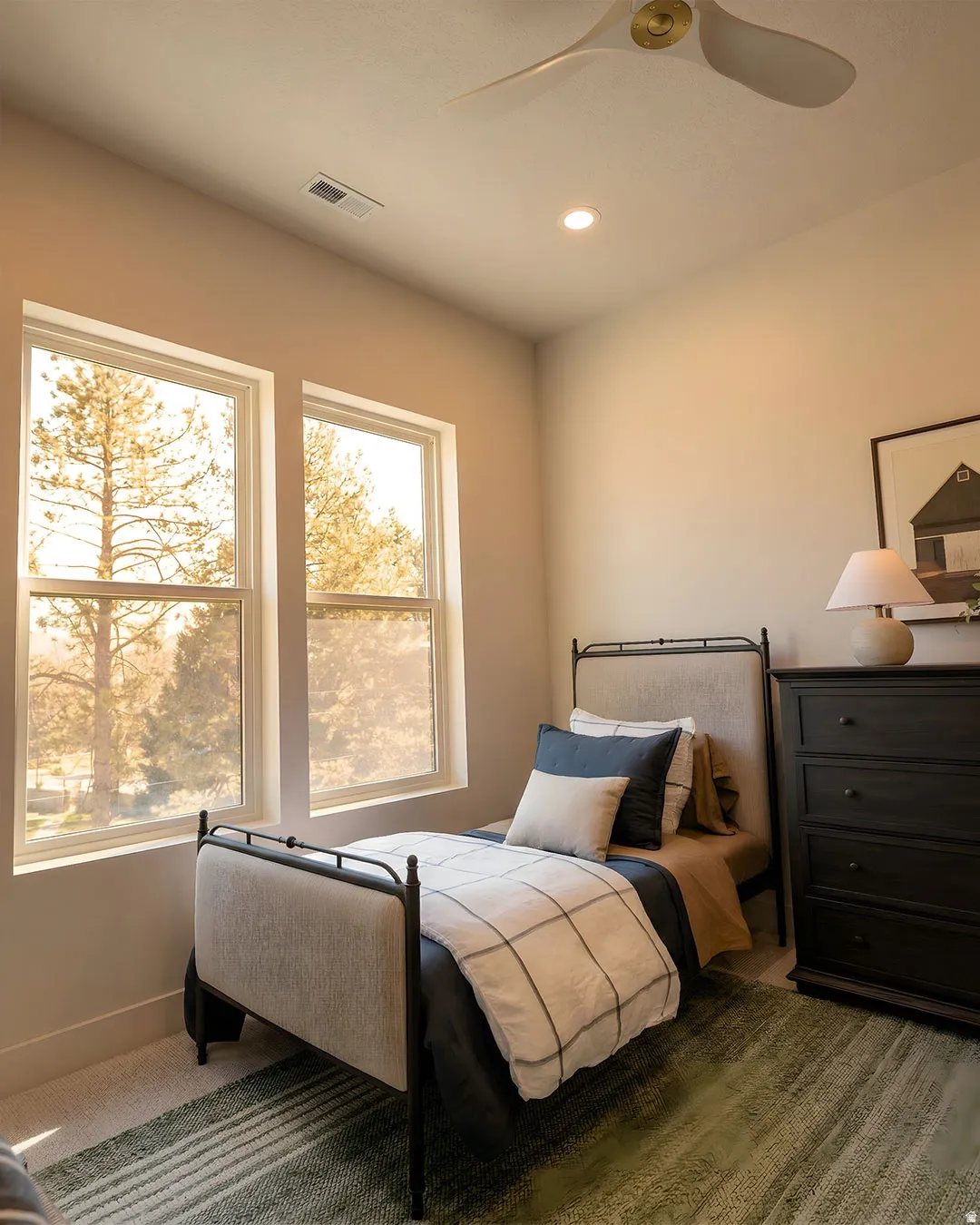Dual windows, recessed ceiling lighting, and a contemporary ceiling fan