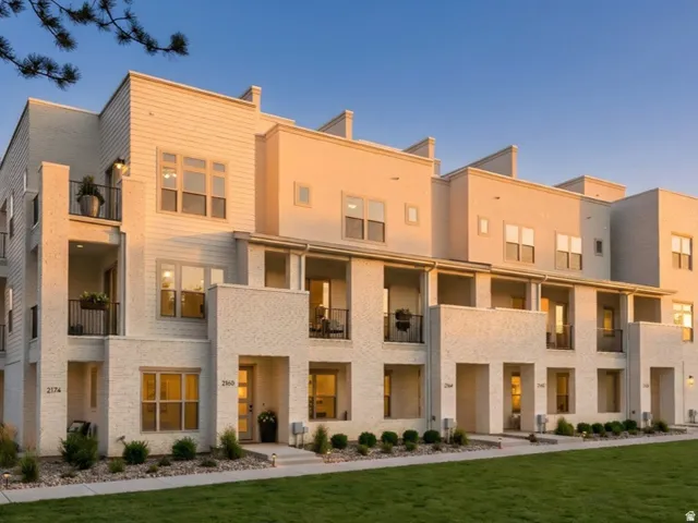 Modern townhome architecture featuring light-colored brick and horizontal siding