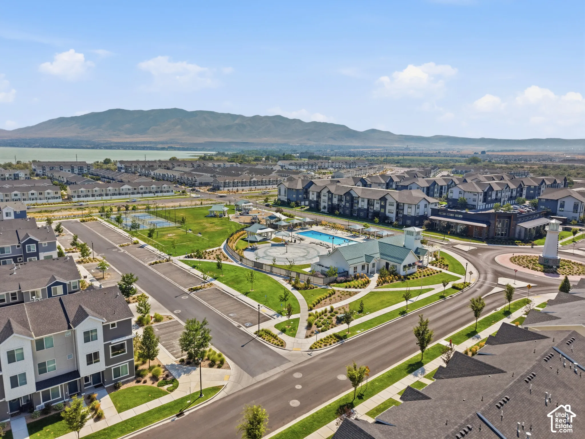 Community amenities including an outdoor swimming pool, tennis courts, and expansive green spaces
