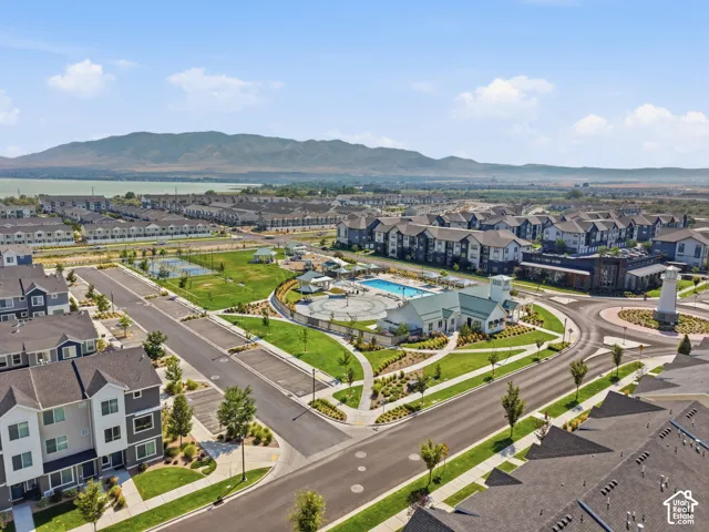 Community amenities including an outdoor swimming pool, tennis courts, and expansive green spaces