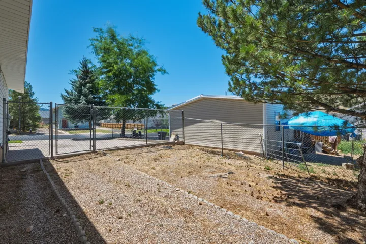 Chain-link fencing with double gates, offering defined property divisions