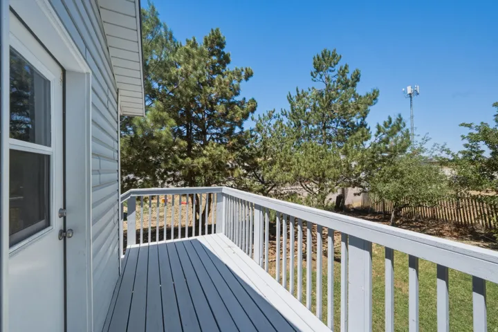 Outdoor deck with painted wood flooring and railings