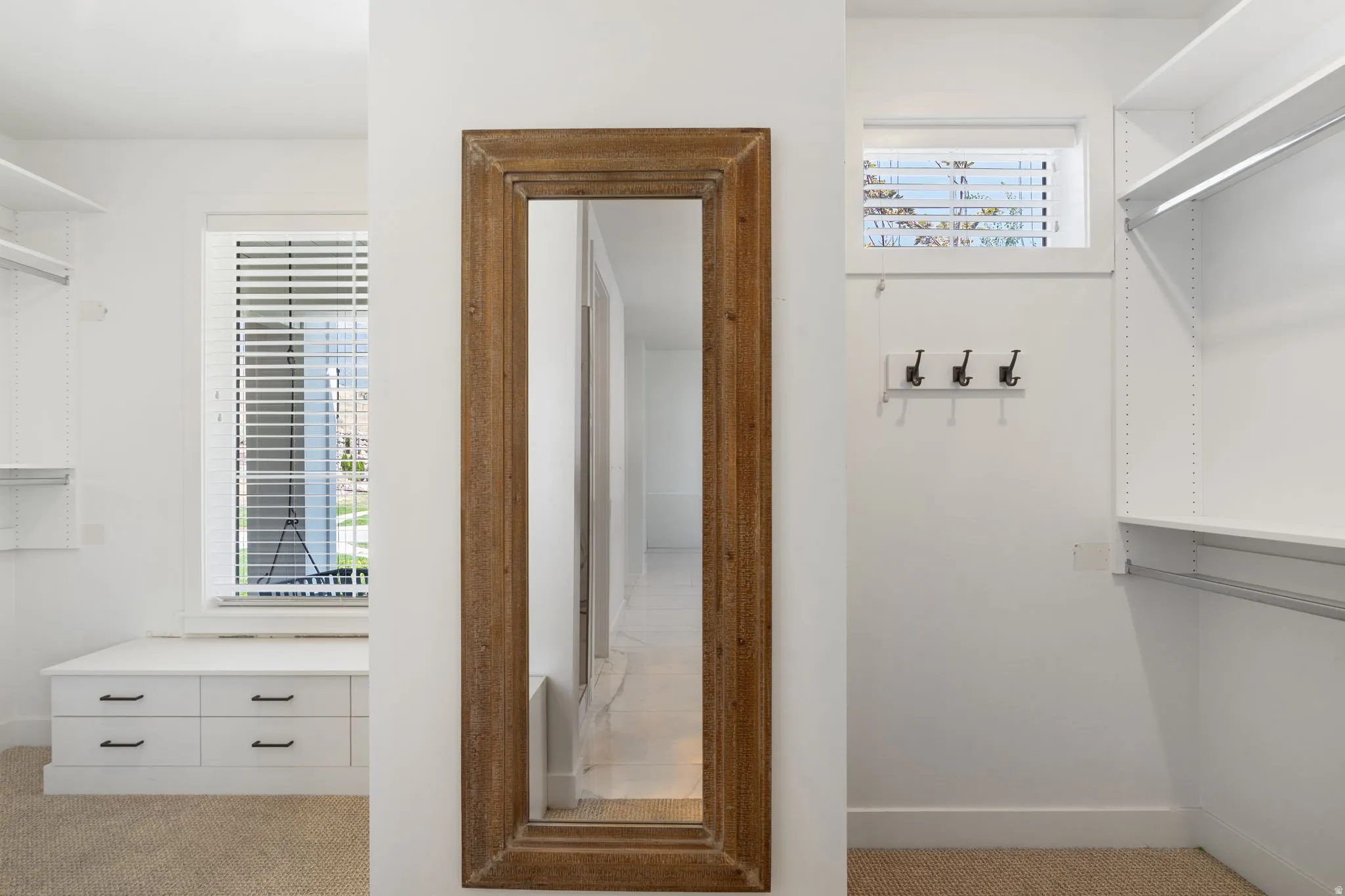 Built-in shelving, built-in drawer storage, and a full-length mirror