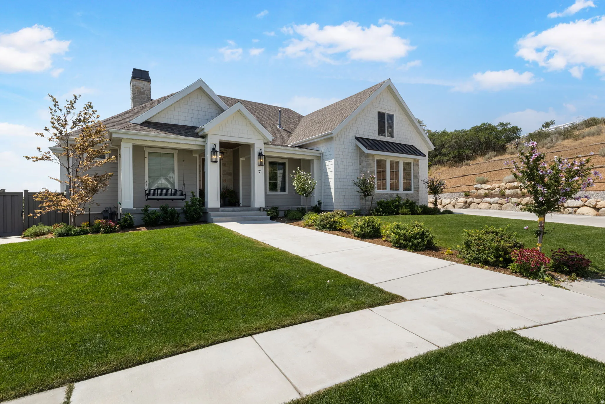 Craftsman-style facade with white siding and gray shingles
