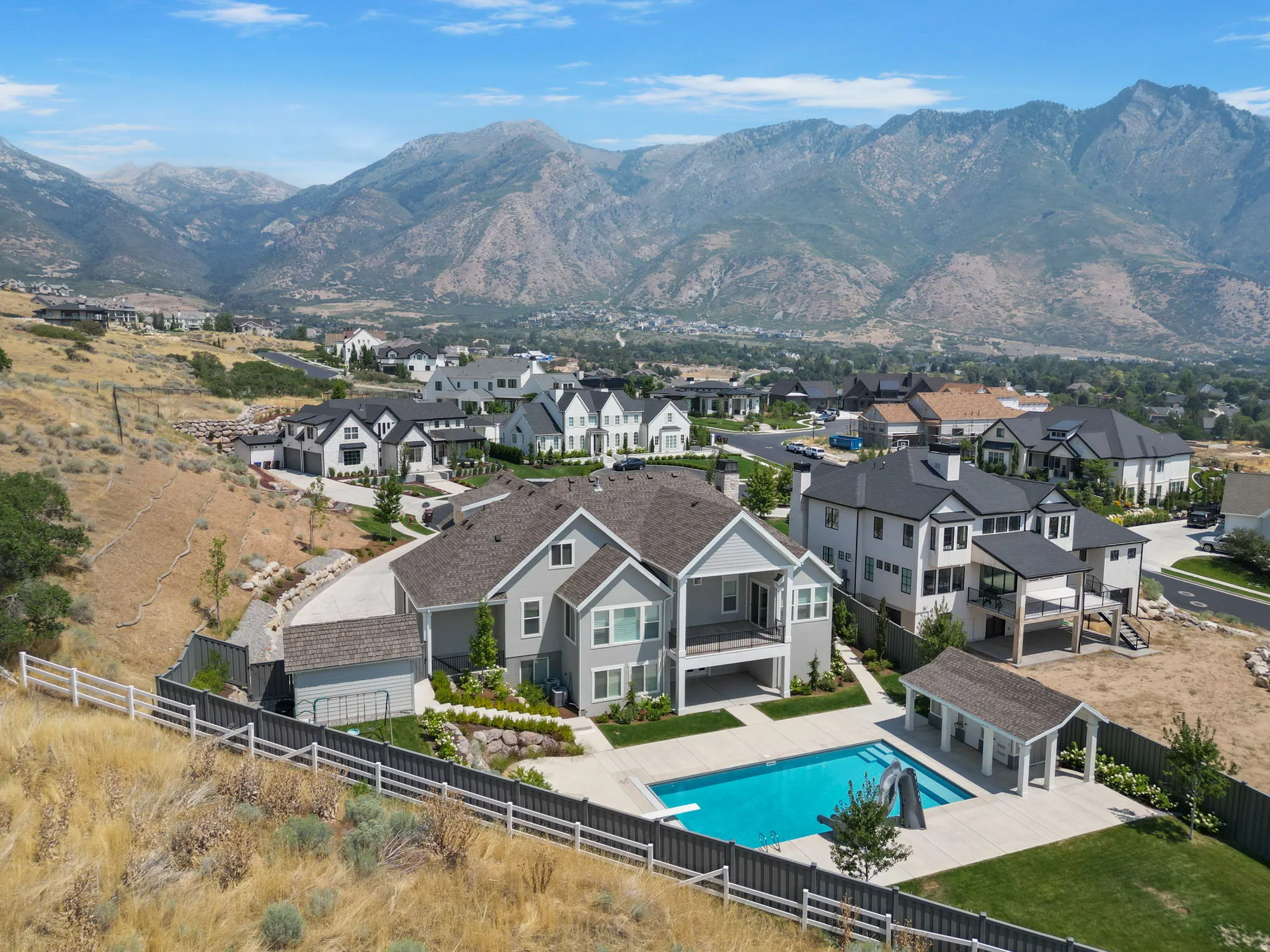 Contemporary residence with a private swimming pool, poolside cabana, and terraced landscaping
