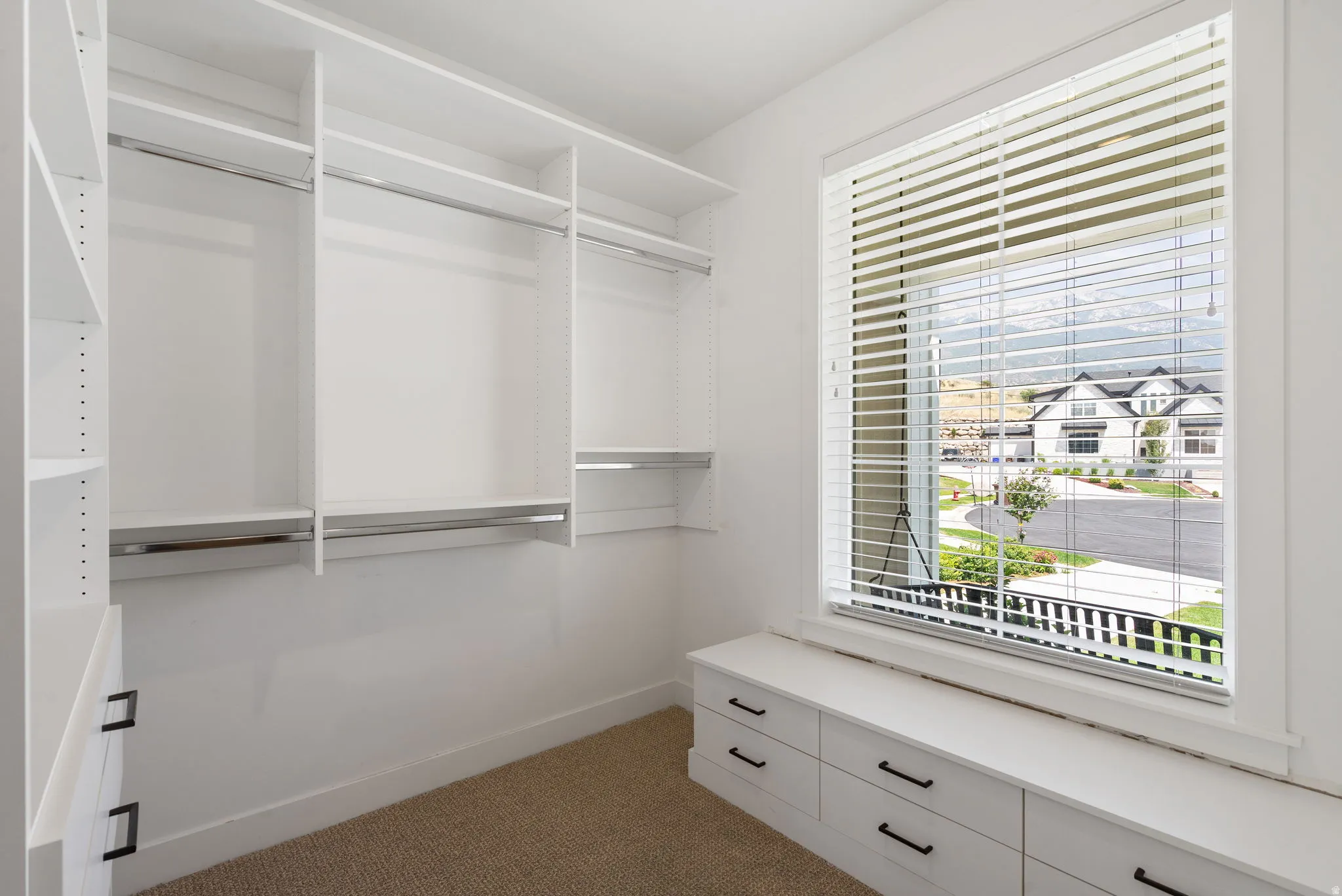 Integrated custom white shelving with hanging rods
