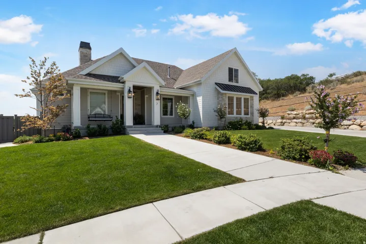 Craftsman-style facade with white siding and gray shingles