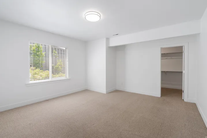 Neutral-toned carpeting throughout with a window offering natural light
