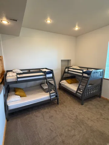 Spacious room with plush carpet flooring and recessed lighting