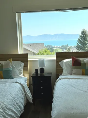 Expansive window offering a broad water and mountain backdrop