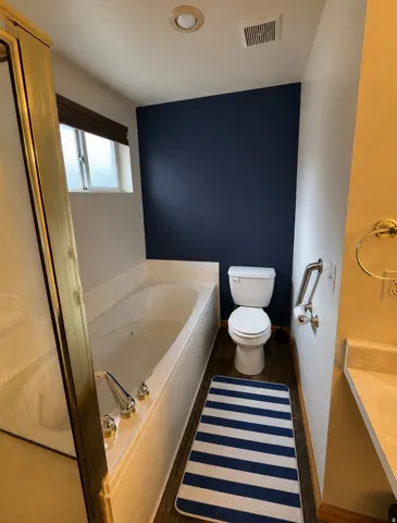 Bathroom featuring a built-in soaking tub with LVP flooring, and a recessed ceiling light
