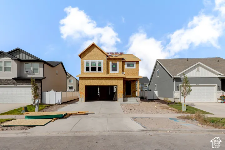 Two-story construction featuring an attached two-car garage and a concrete driveway