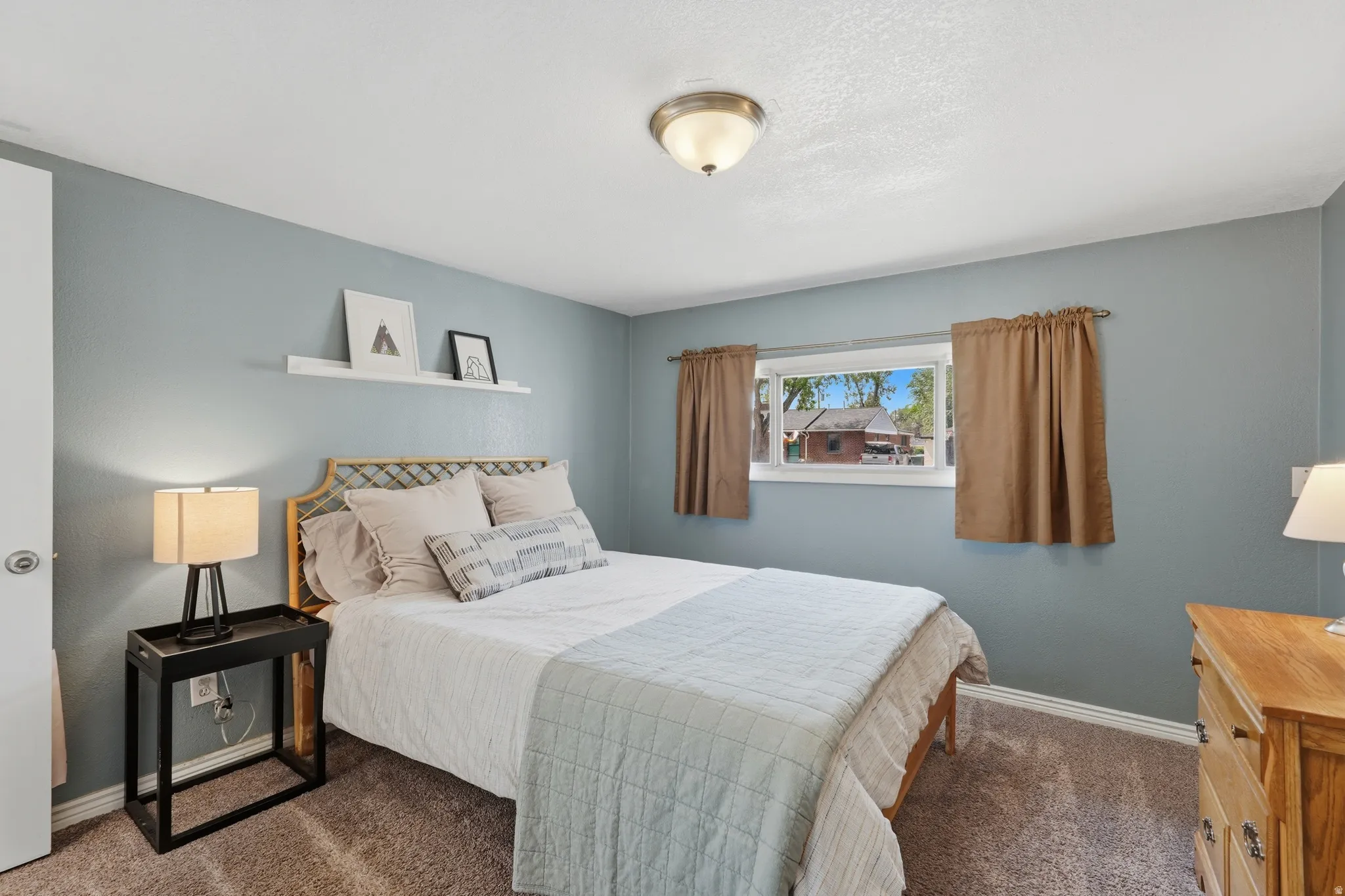 Carpeted flooring, single window, wall-mounted shelf, flush mount ceiling light fixture