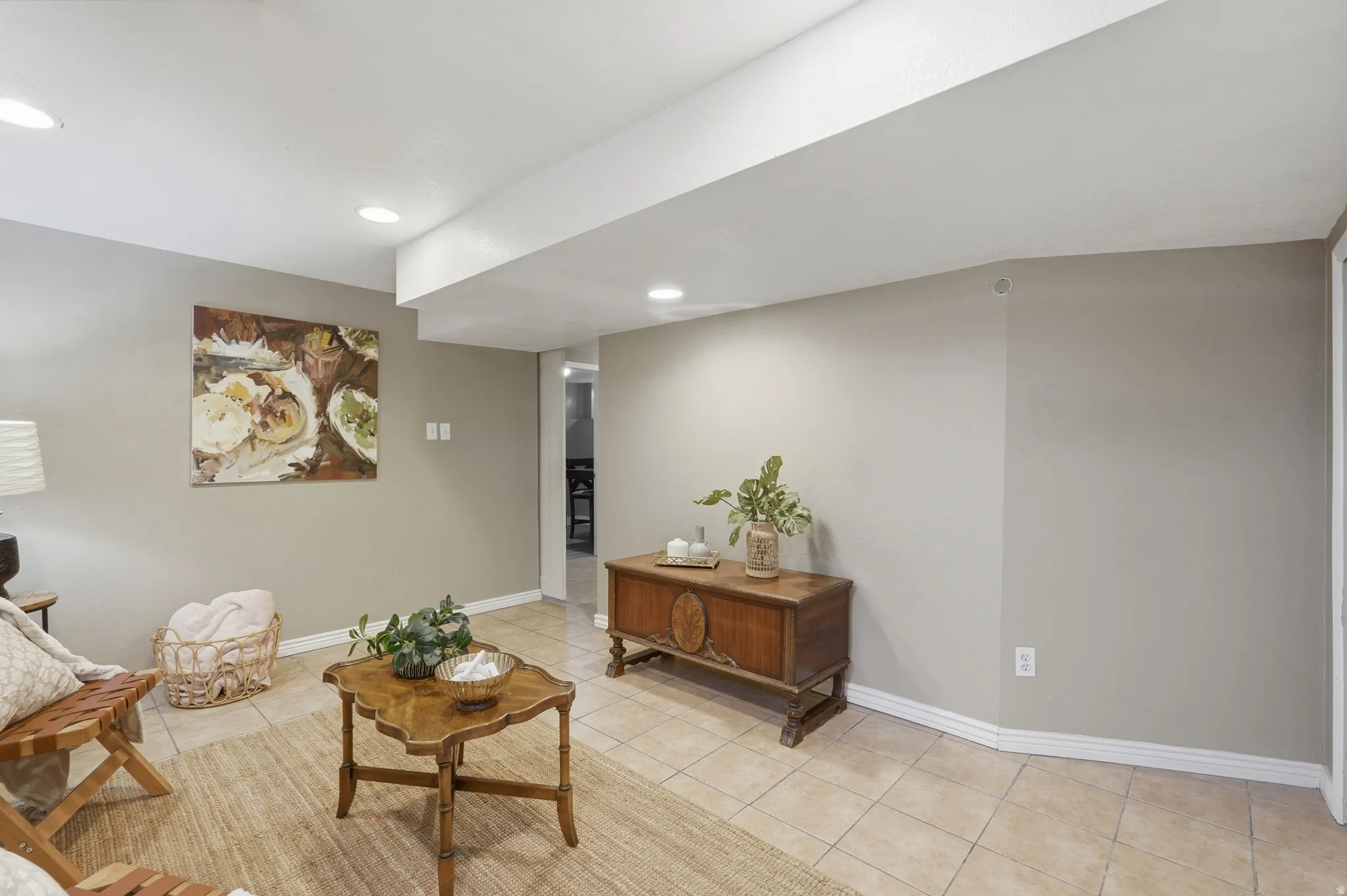 Spacious recreation room featuring neutral wall finishes, recessed ceiling lighting, and tile flooring throughout