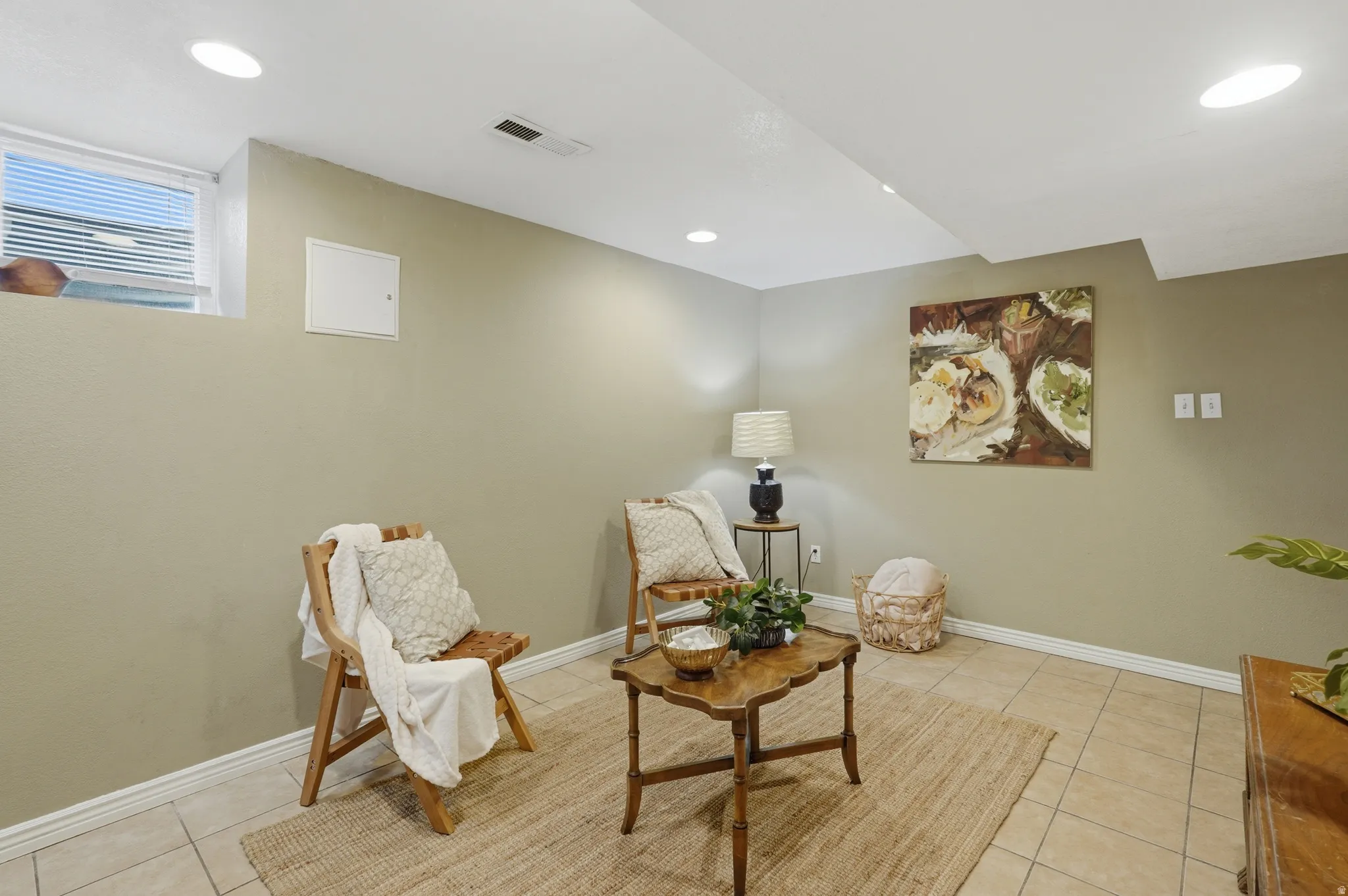 Recessed ceiling lighting illuminates the space, featuring a window with integrated blinds