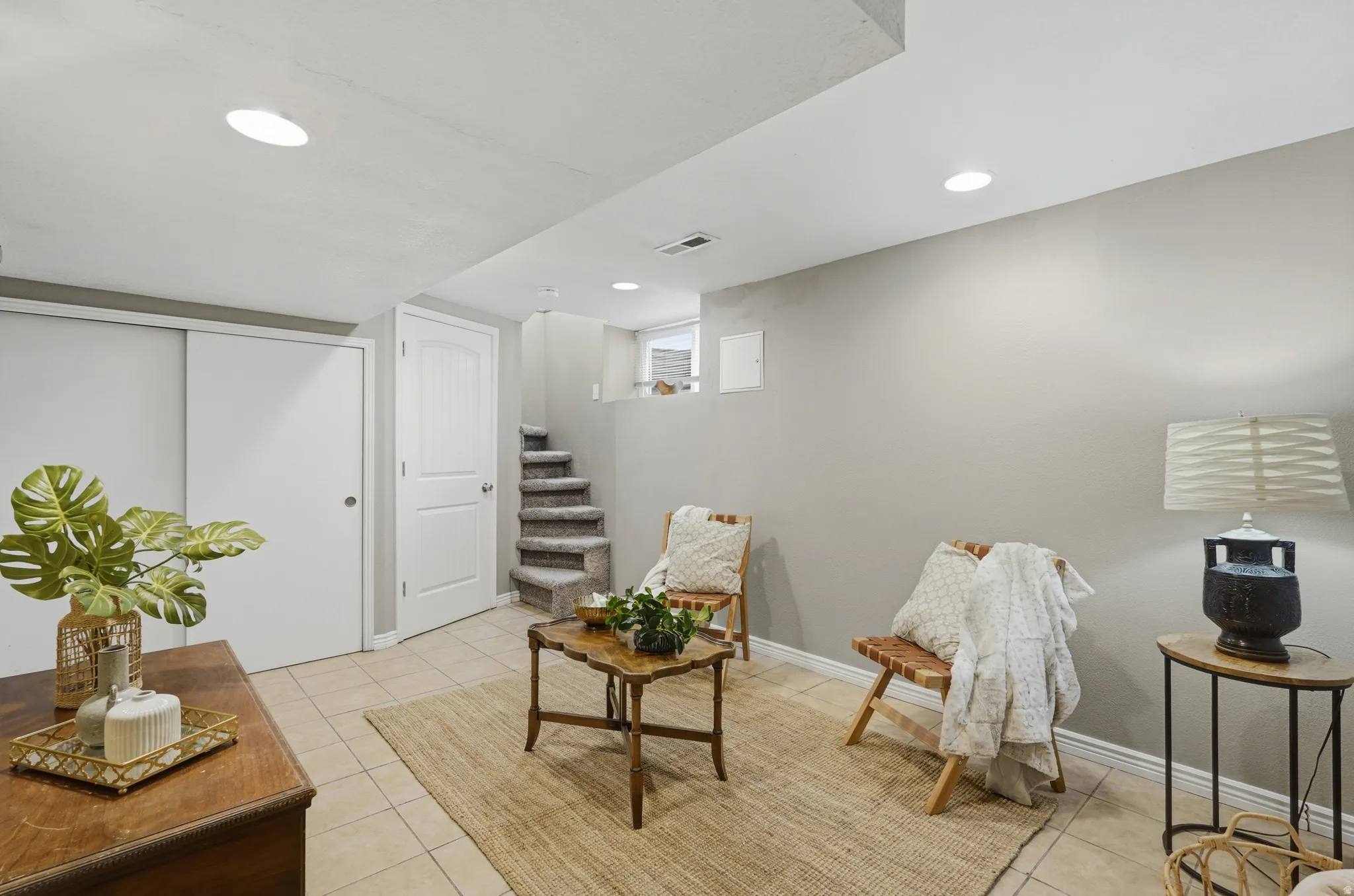 Finished basement featuring recessed ceiling lighting, neutral wall finishes, and tile flooring