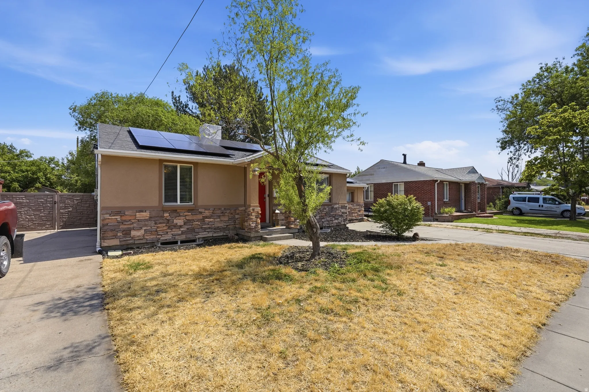 Charming single-story residence featuring a refreshed exterior with mixed material cladding, solar panels, and an updated front addition