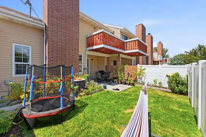 Manicured lawn with a white vinyl privacy fence