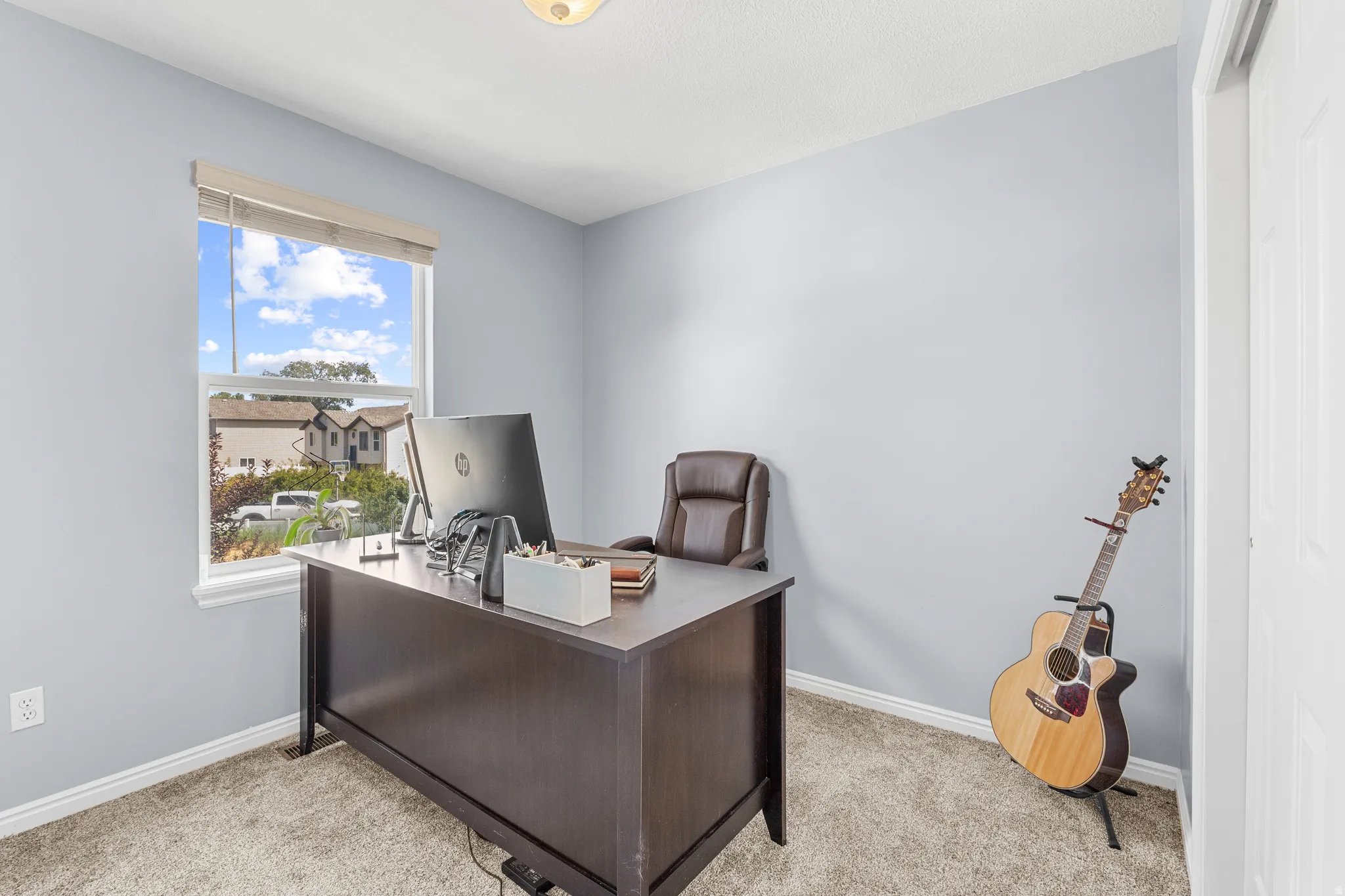 Light gray wall paint, white trim, and neutral-toned carpet flooring