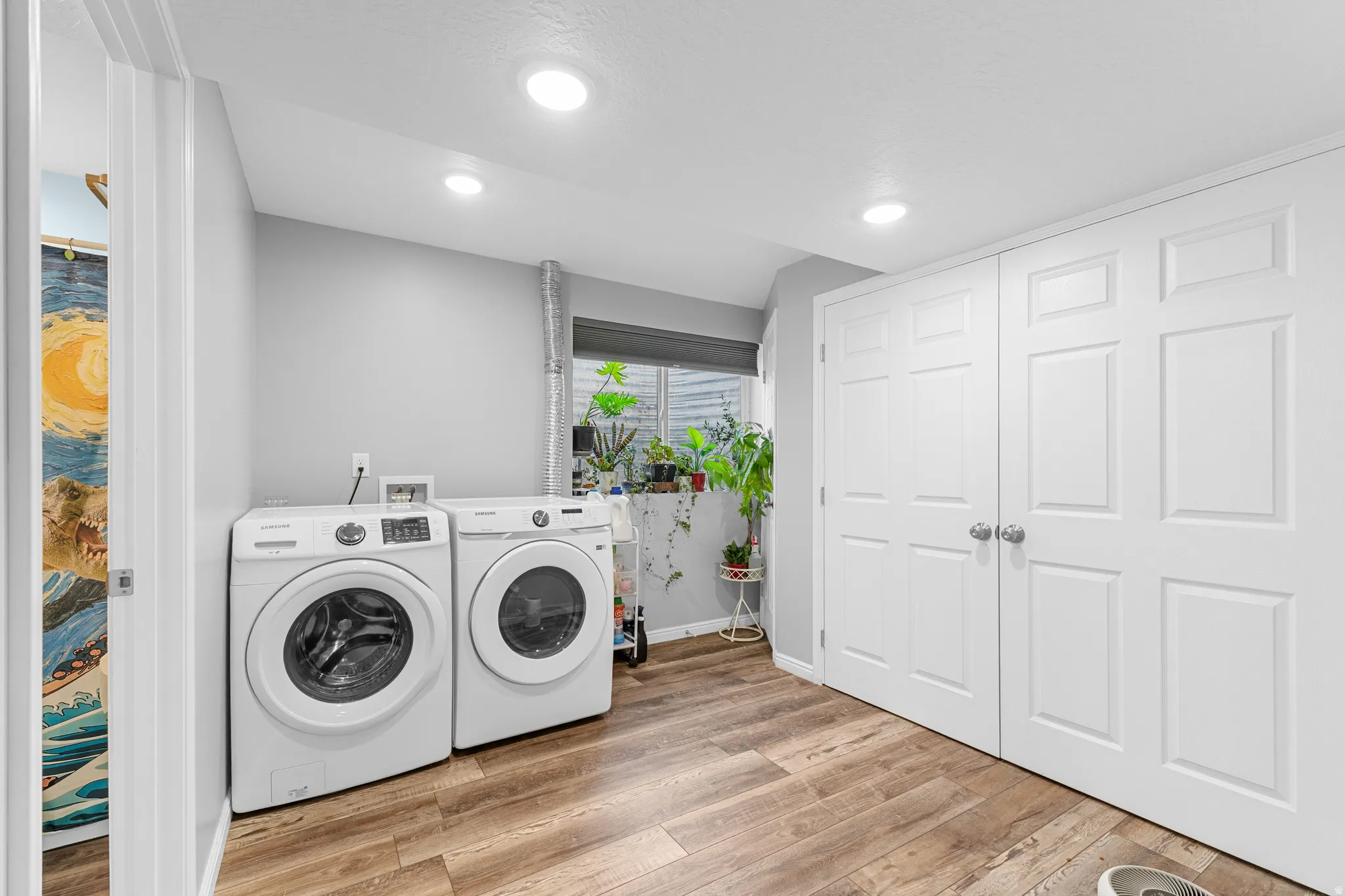 Recessed lighting, wood-finish flooring, and white paneled doors