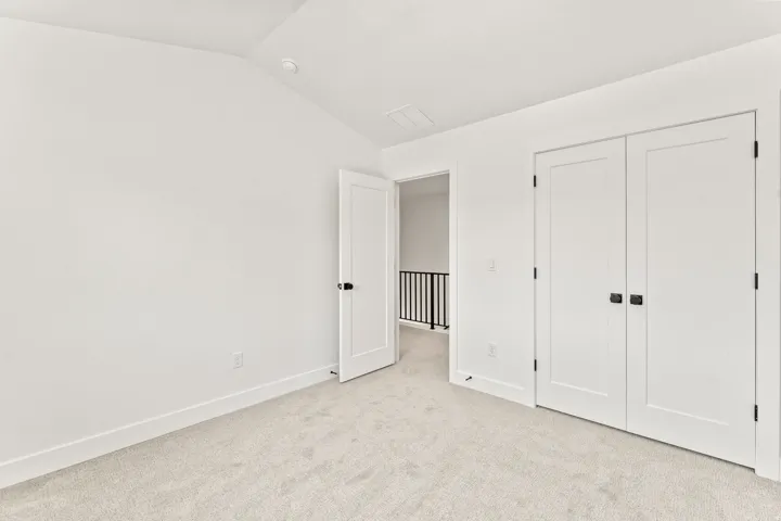 Plush carpeting, crisp white walls, and a recessed ceiling light