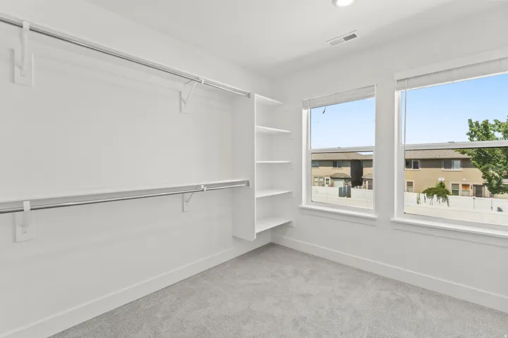 White walls with integrated shelving and hanging rods