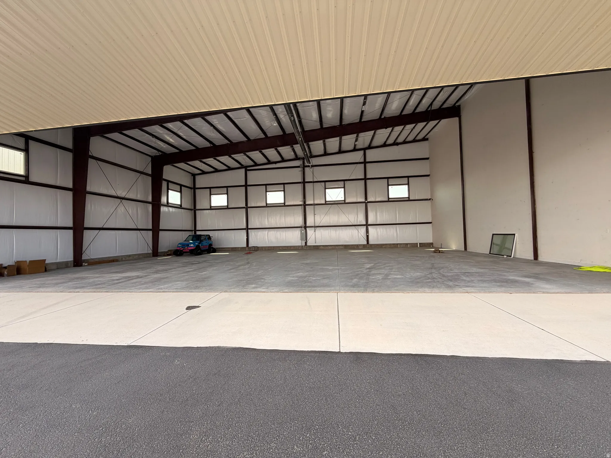 Expansive interior featuring an open layout, high ceilings, and concrete flooring