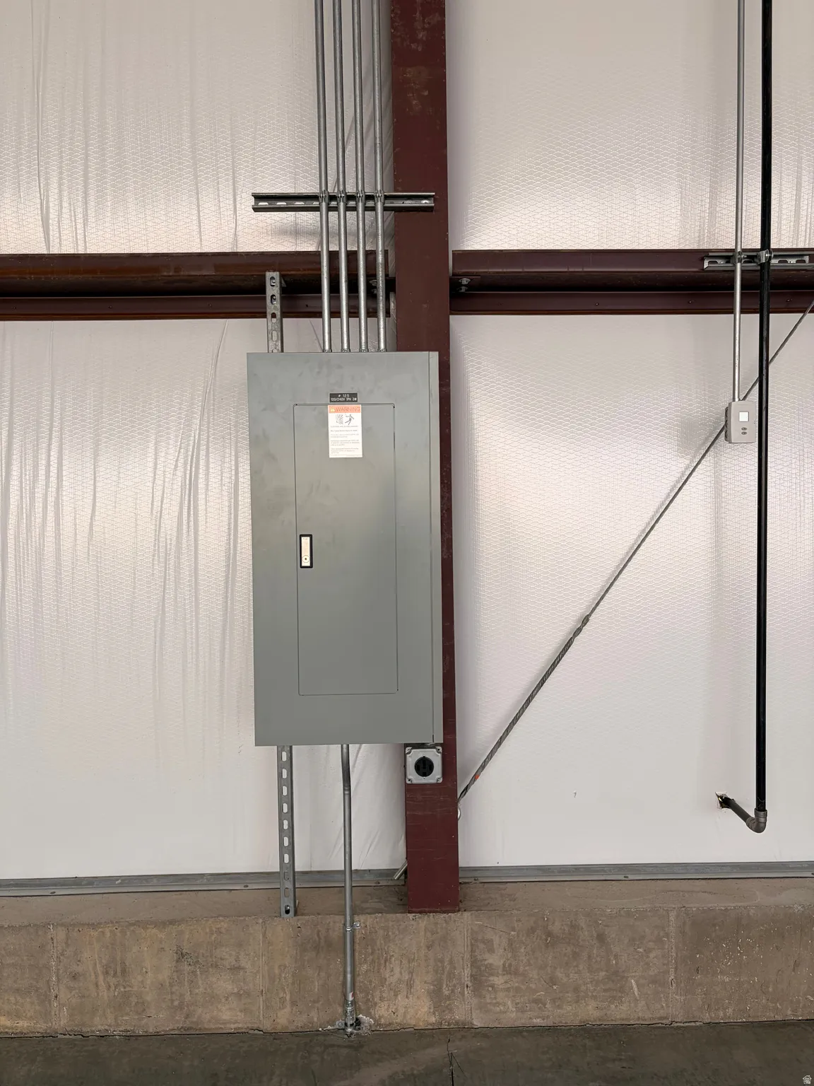 Commercial-grade electrical panel with multiple conduit runs