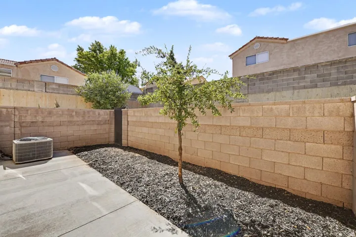 Paved concrete patio area with a block wall perimeter