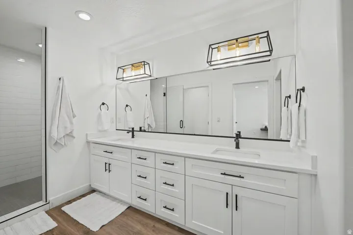 Dual vanity with white cabinetry and matte black hardware