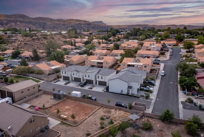 Residential community featuring a mix of single-family homes and multi-unit dwellings with mountain backdrops