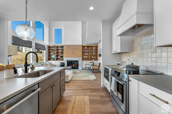Gourmet kitchen featuring a large island, stainless steel appliances, and a tile backsplash