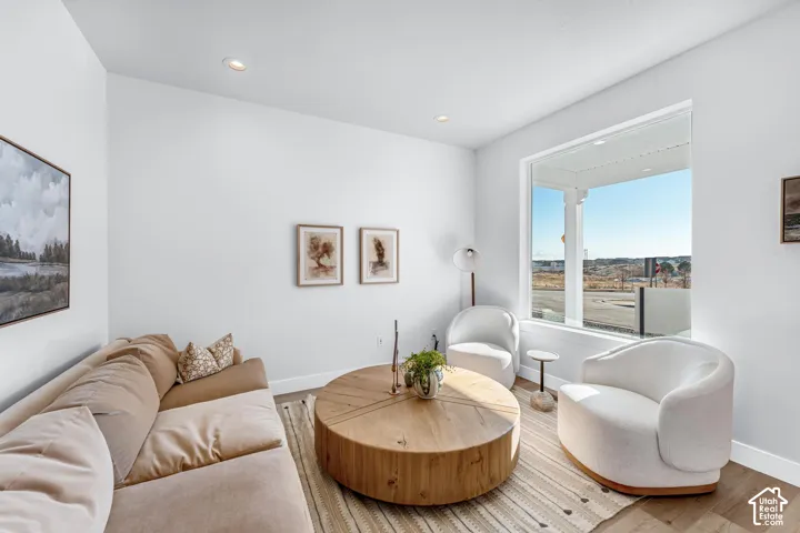 Recessed lighting, large picture window, wood-finish flooring