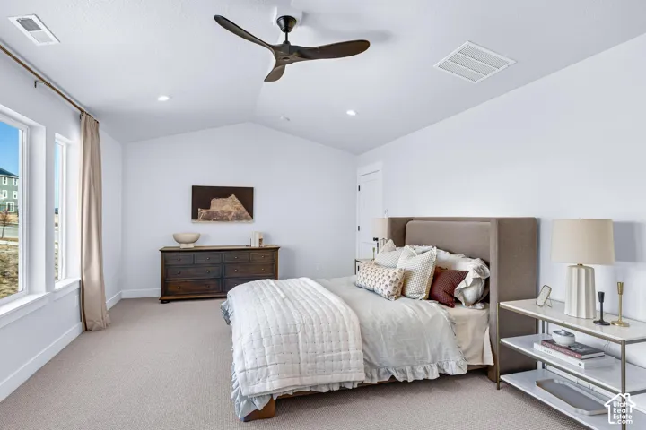 Vaulted ceiling with a contemporary ceiling fan, dual windows, and recessed lighting