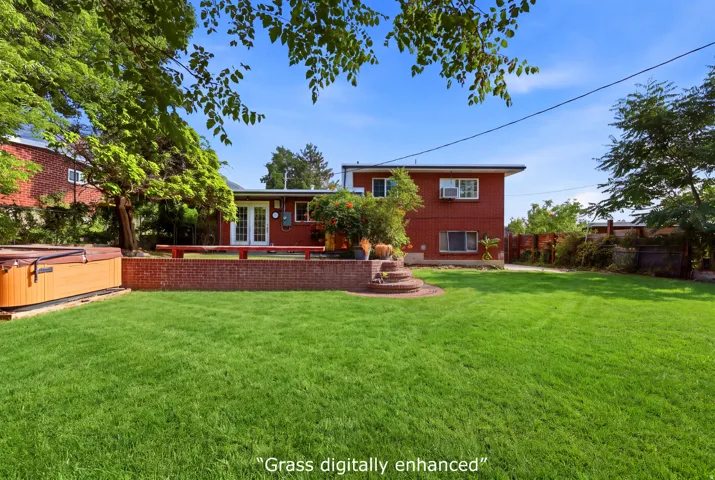 Red brick exterior with white trim windows and a white double door entrance