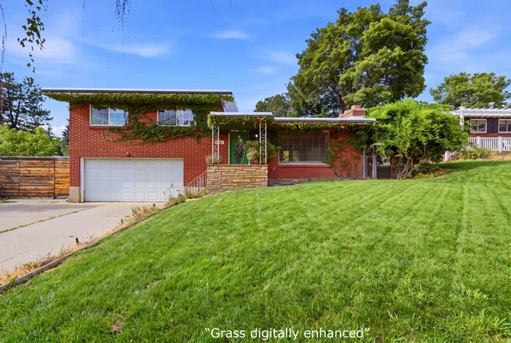 Brick exterior with climbing greenery, integrated garage, stone accents, and a covered entry