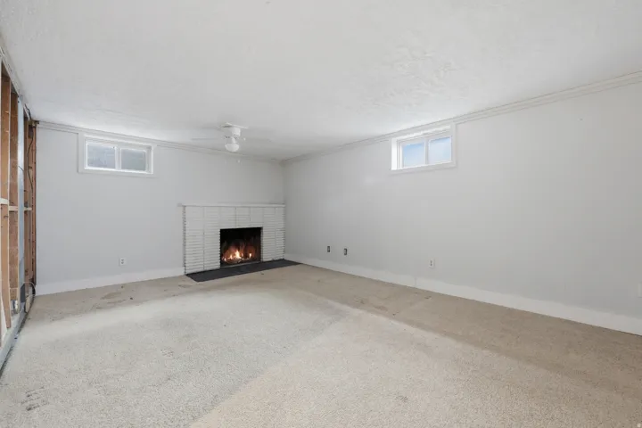 Fireplace with white tile surround and dark hearth