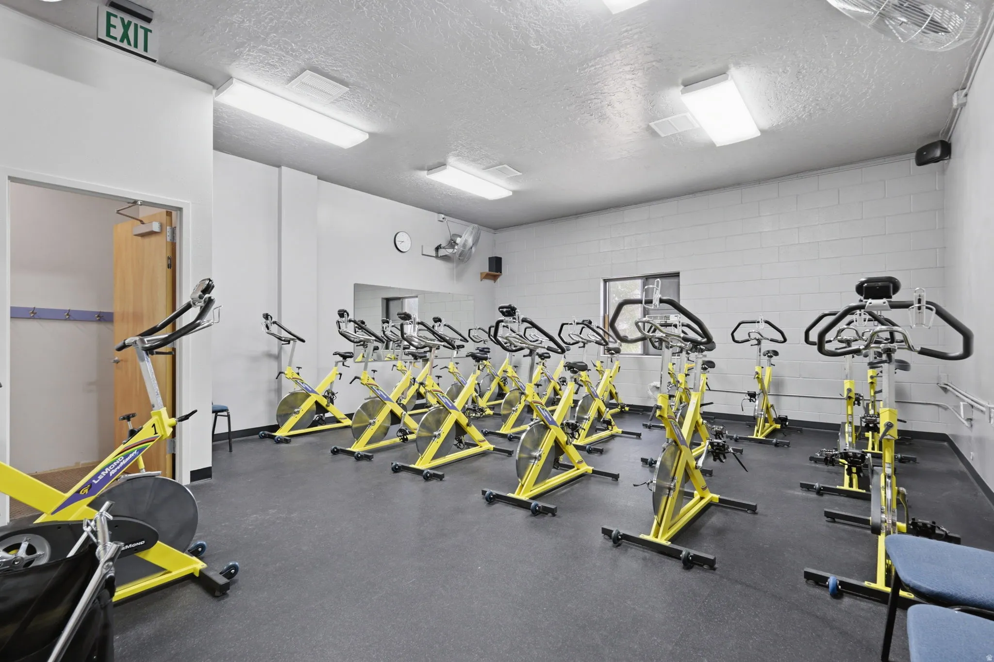 Fitness room featuring resilient flooring and ample overhead lighting